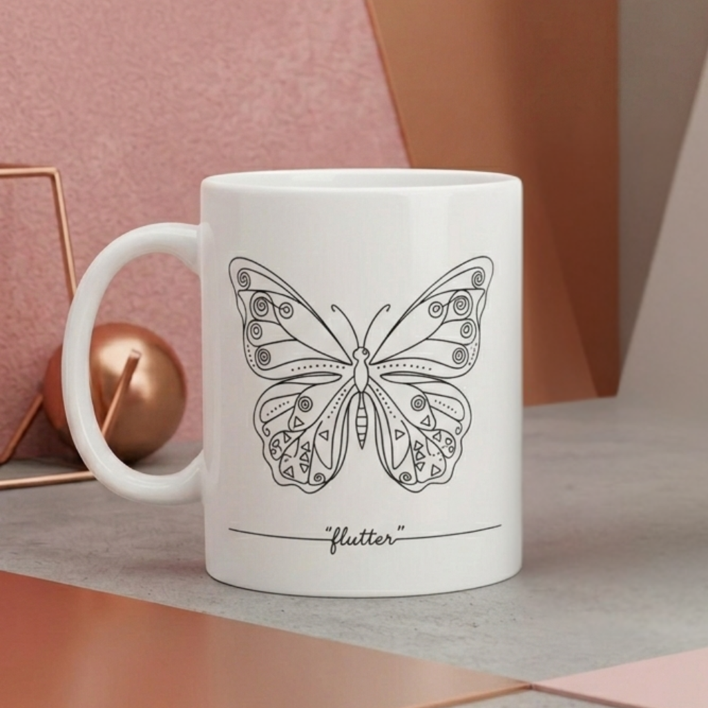 White mug with a black butterfly design and 'flutter' text on a geometric background
