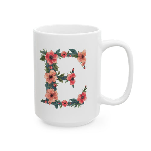 White mug with floral letter 'E' design on a white background