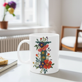 White mug with floral design on a table with a blurred background