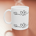 White mug with black heart designs on a wooden surface