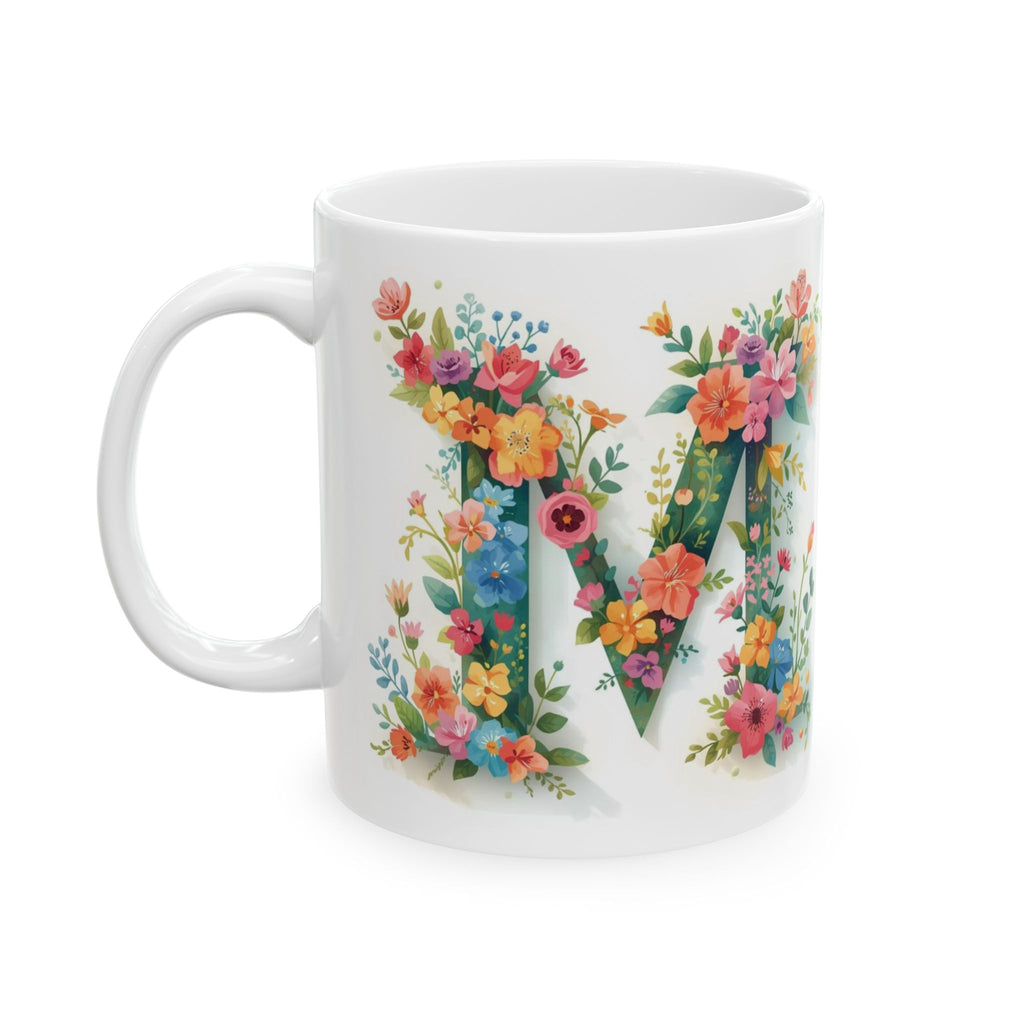 White mug with floral letter 'M' design on a white background