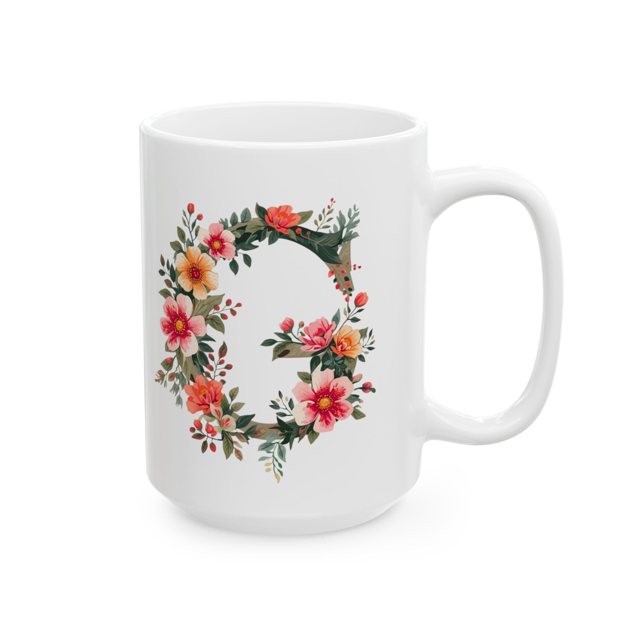 White mug with floral letter 'G' design on a white background
