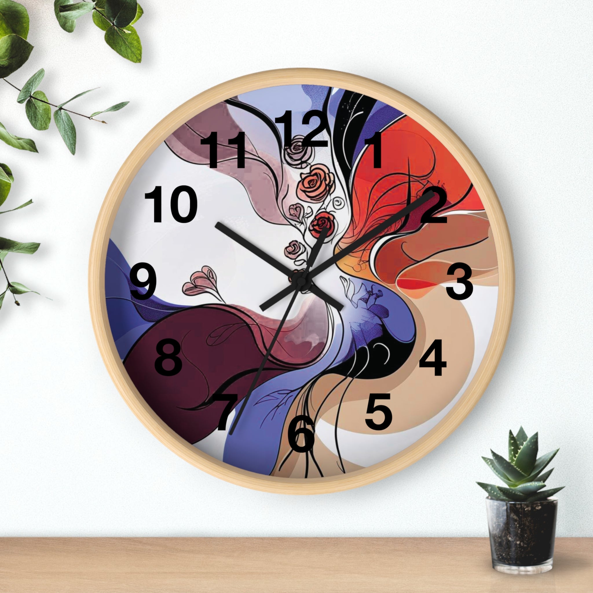 Colorful abstract wall clock on a white background with a plant and small pot.