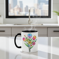 White mug with black handle featuring colorful floral design on a kitchen counter.