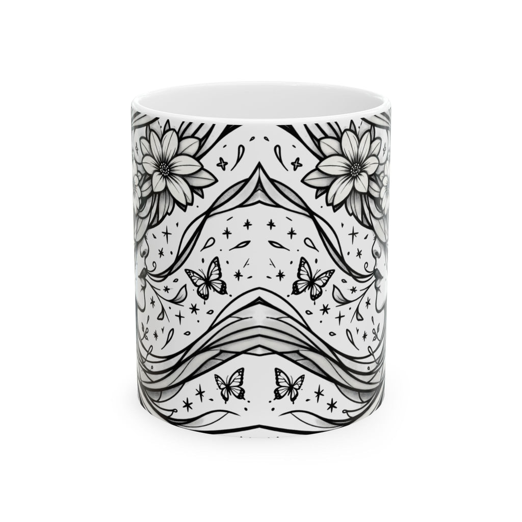 White mug with black floral and butterfly pattern on a white background